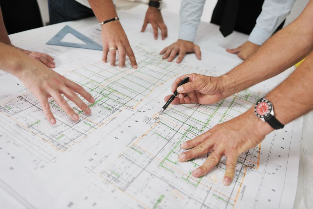 Several professionals working on a project around the table